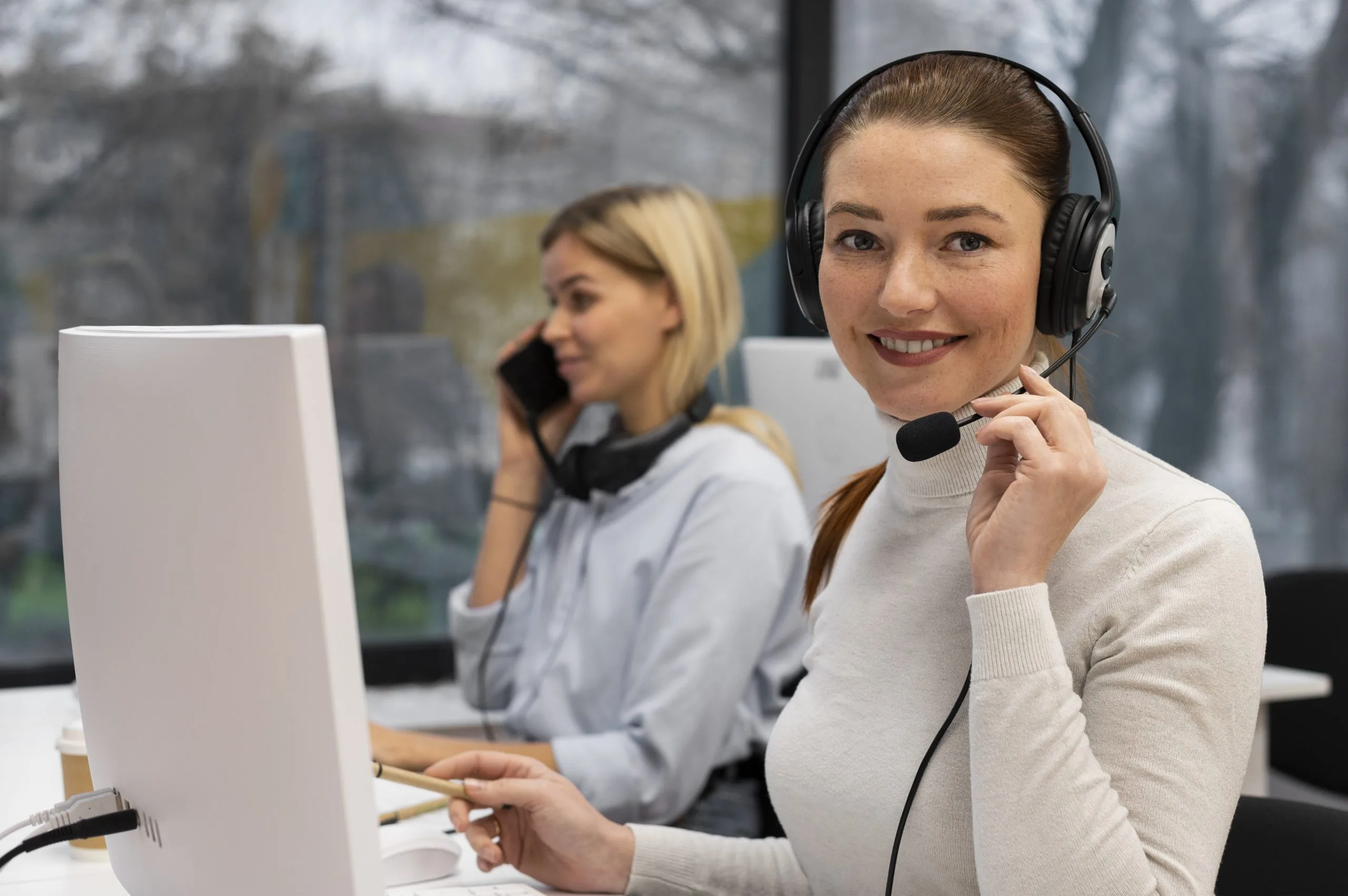 woman-working-call-center-talking-with-clients-using-headphones-microphone-scaled